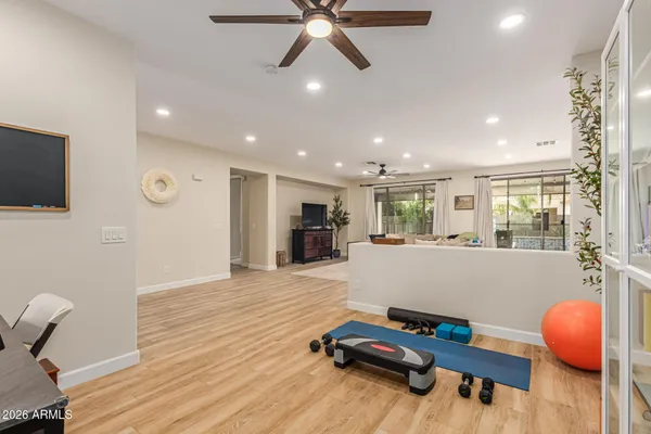 a living room with furniture and a wooden floor