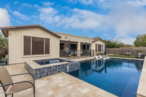 a view of a patio with swimming pool table and chairs