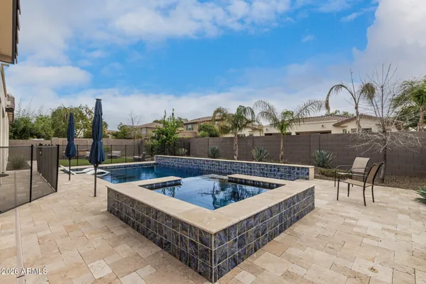 a view of a swimming pool with a lounge chair