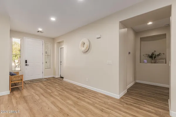 an empty room with wooden floor and bathroom
