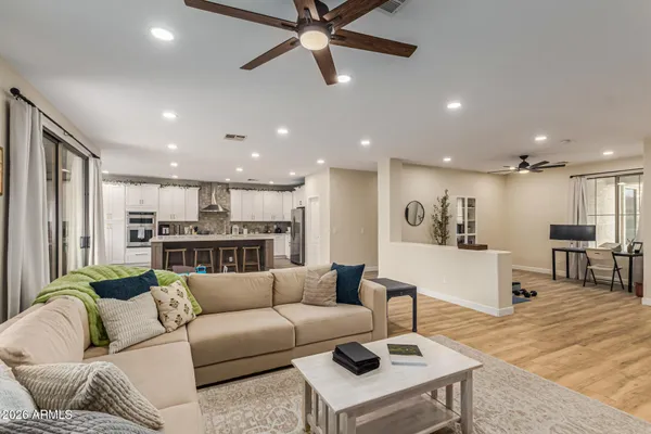 a living room with furniture and kitchen view