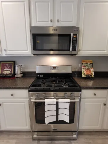 a kitchen with granite countertop a refrigerator and a sink