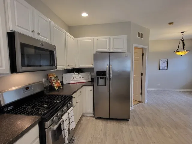 a kitchen with a sink cabinets and a table
