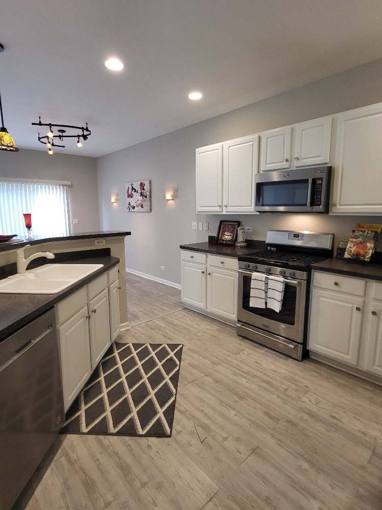 2949 Brossman Street Naperville, IL 60564 - Photo 19 of 61 a kitchen with stainless steel appliances a stove sink microwave and cabinets
