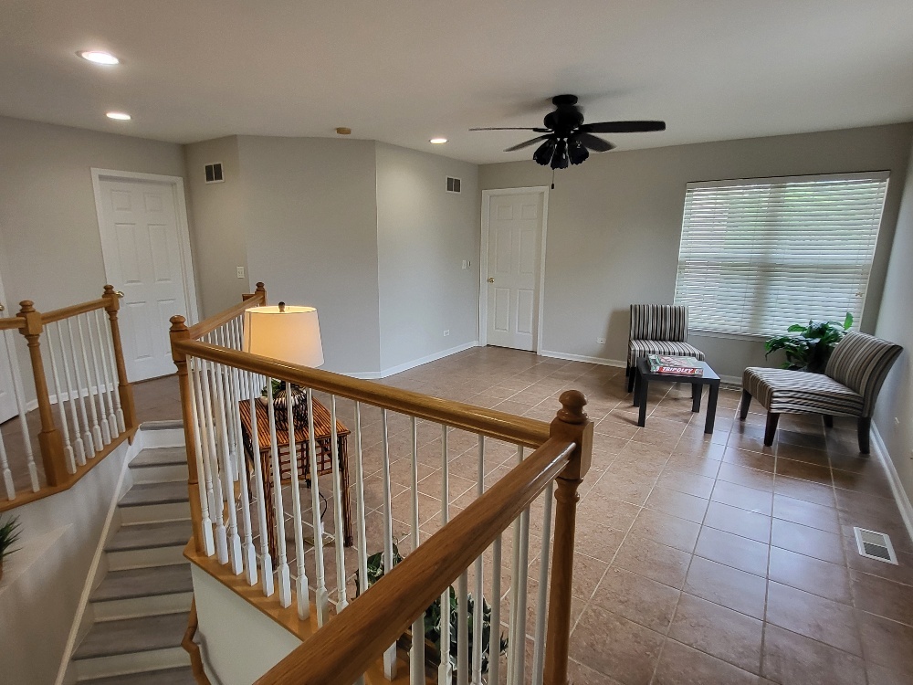 2949 Brossman Street Naperville, IL 60564 - Photo 24 of 61 a view of a hallway with couches and a dining table chairs