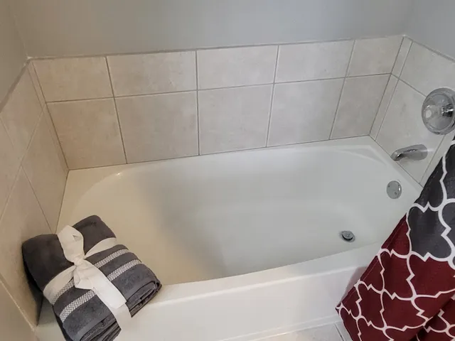 a spacious bathroom with a toilet a sink and mirror