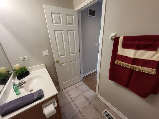 a bathroom with a sink toilet and mirror
