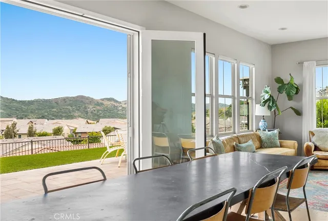 a living room with furniture floor to ceiling window and wooden floor