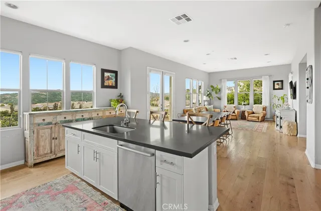 a kitchen with counter top space a sink cabinets and wooden floor