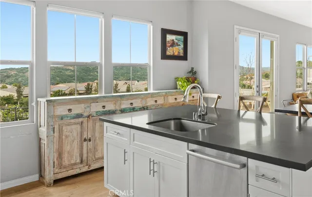a kitchen with kitchen island a sink and a large window