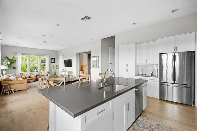 a kitchen with counter space cabinets a sink and stainless steel appliances