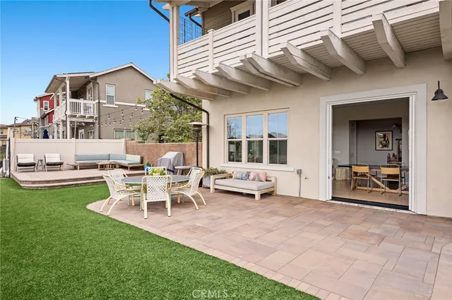 a view of a house with backyard and sitting area