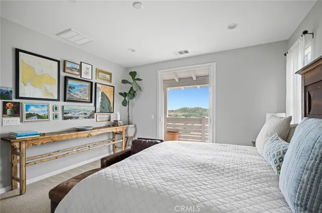 a bedroom with a bed and a large window