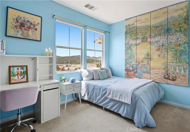 a bedroom with a bed and a large window