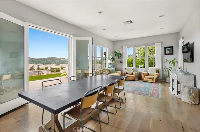 a view of a dining room with furniture window and wooden floor