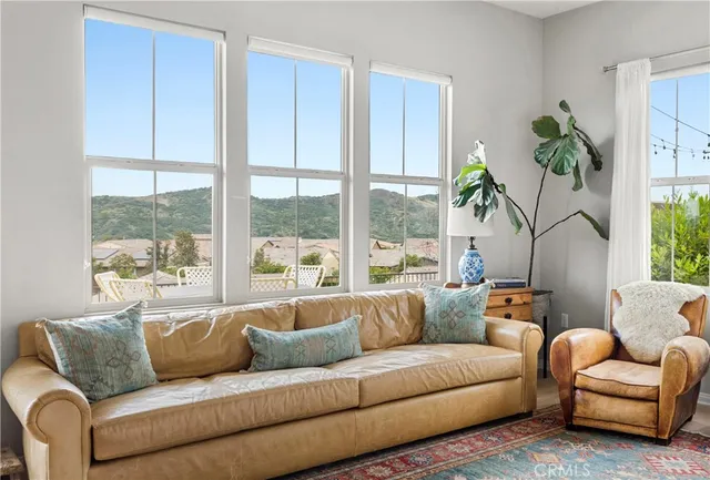 a living room with furniture and a large window