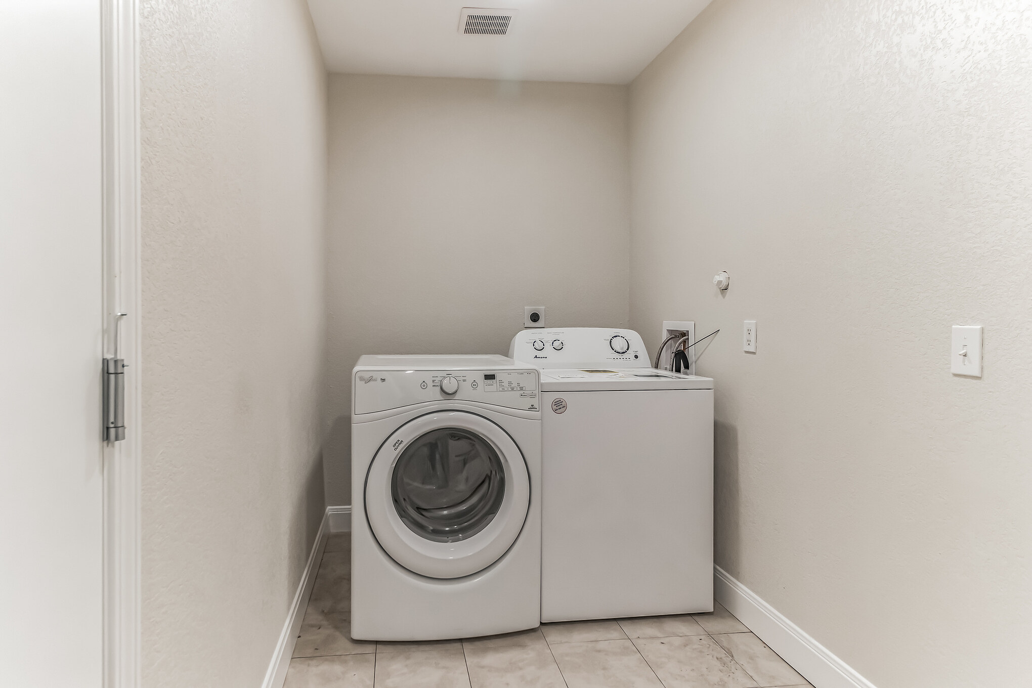 11406 Ruffed Grouse Drive Austin, TX 78758 - Photo 21 of 22 A dedicated laundry alcove features durable tiled flooring and neutral walls.
