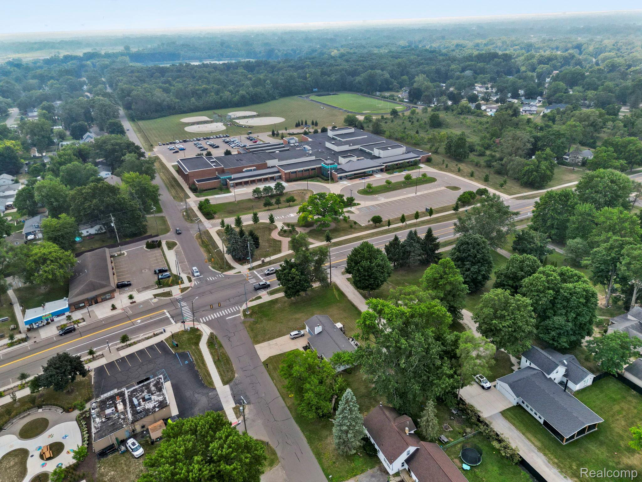 2891 Culbertson Avenue Rochester, MI 48307 - Photo 27 of 27 Aerial perspective showcasing a community with varied structures, extensive green spaces, and paved thoroughfares