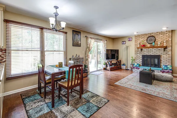 a view of a livingroom with furniture window and wooden floor