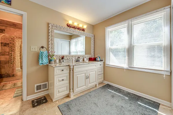 a spacious bathroom with a double vanity sink and a mirror