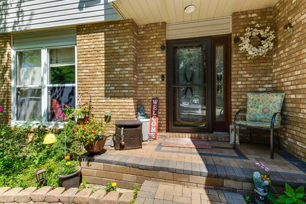 a front view of a house with outdoor seating and plants