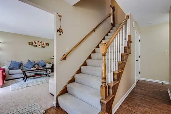 a view of entryway and hall with wooden floor