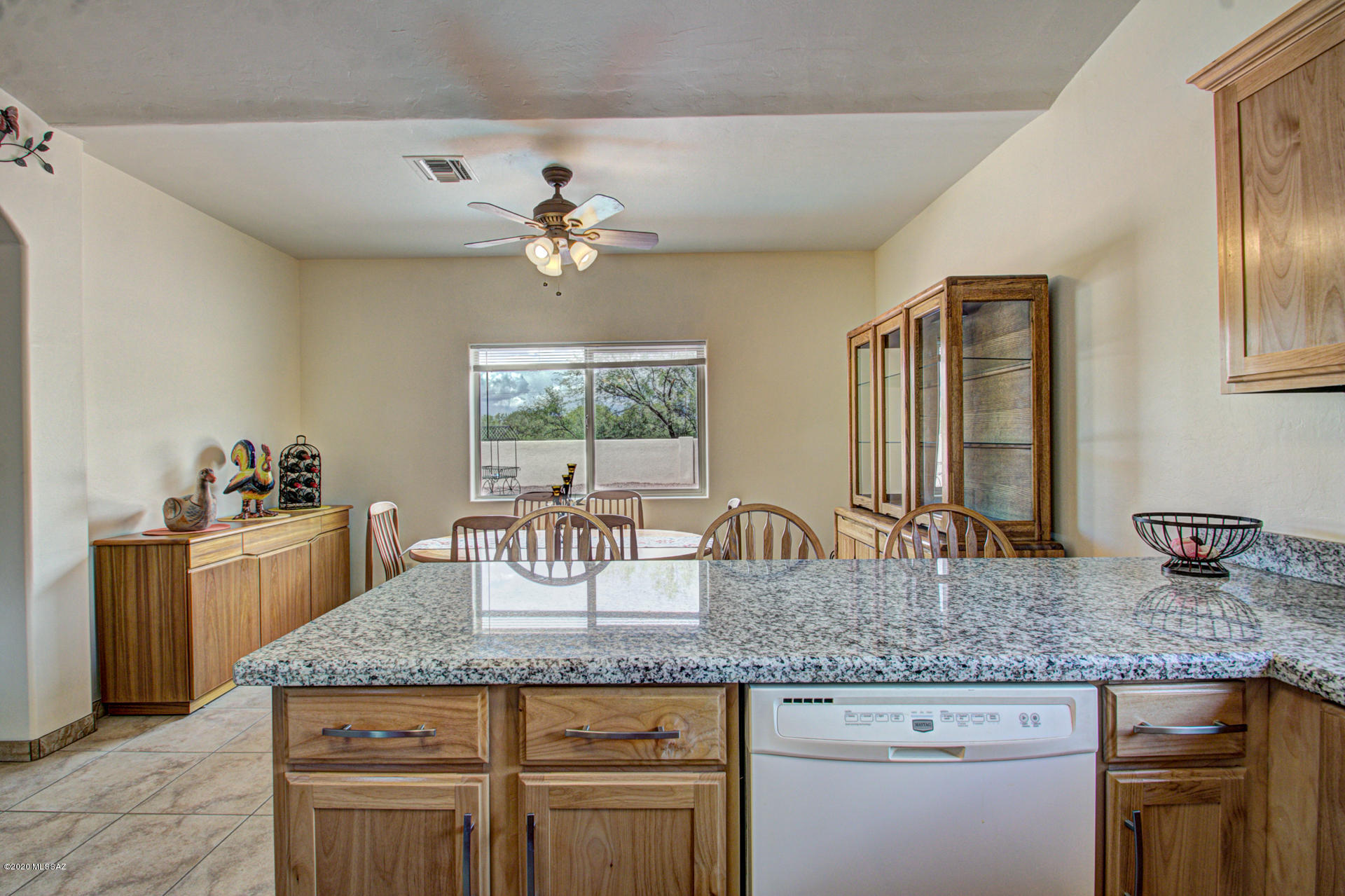 1689 Círculo Alameda Rio Rico, AZ 85648 - Photo 13 of 26 a kitchen with kitchen island granite countertop wooden floor and center island