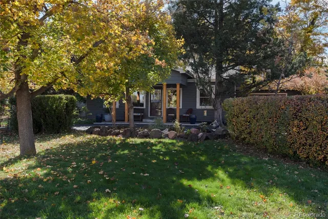 a backyard of a house with yard and outdoor seating