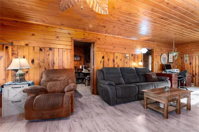 a view of a livingroom with furniture and a large window