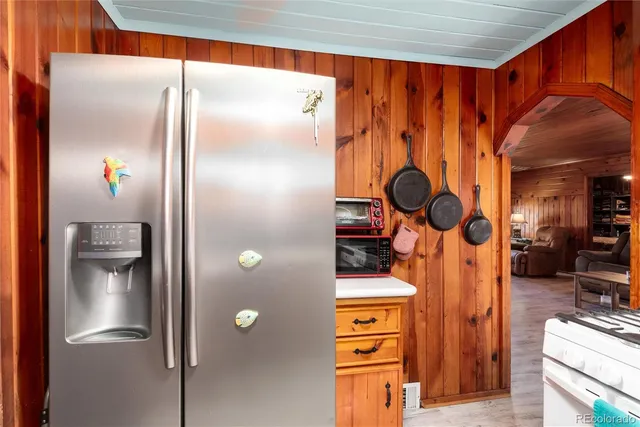 a bed sitting in a spacious bedroom next to a window