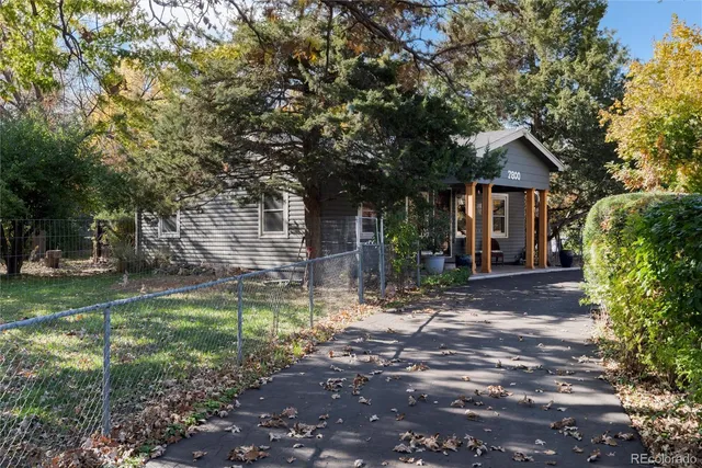 a living room with furniture a fireplace a clock and a chandelier