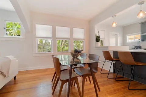 a view of a dining room with furniture and a window