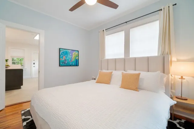 a bedroom with a bed and a large window