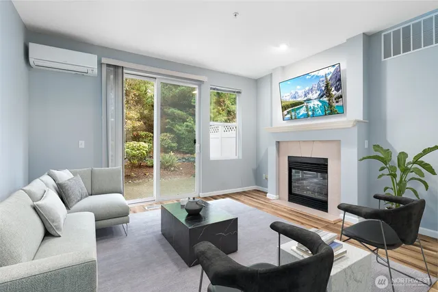 a living room with furniture a large window and a fireplace