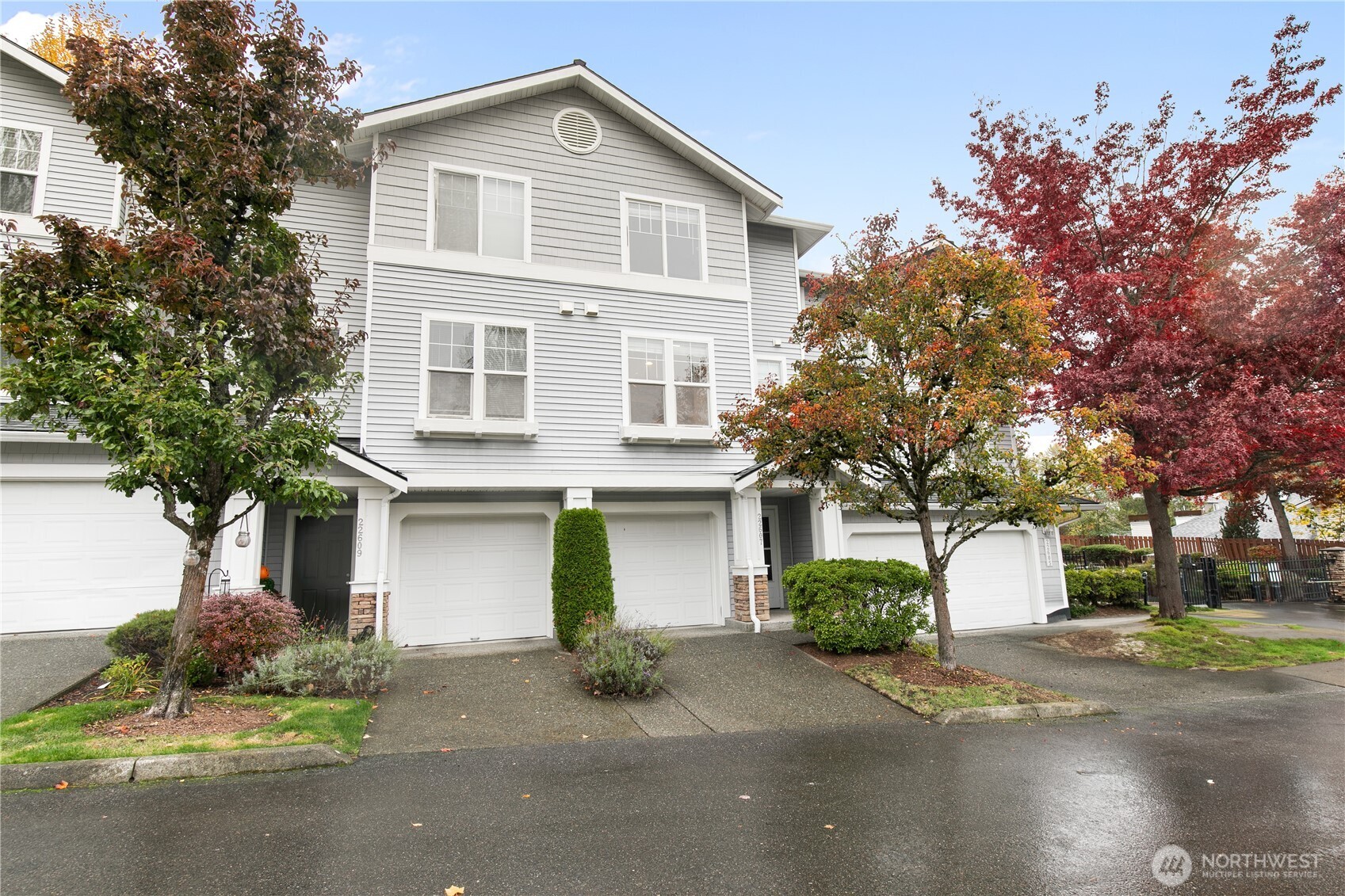22607 42nd Place South, Unit 13 Kent, WA 98032 - Photo 16 of 19 a front view of a house with a yard and garage