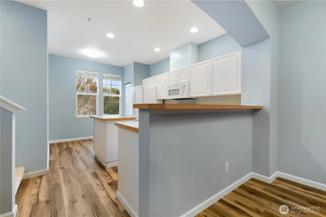 a view of kitchen and wooden floor