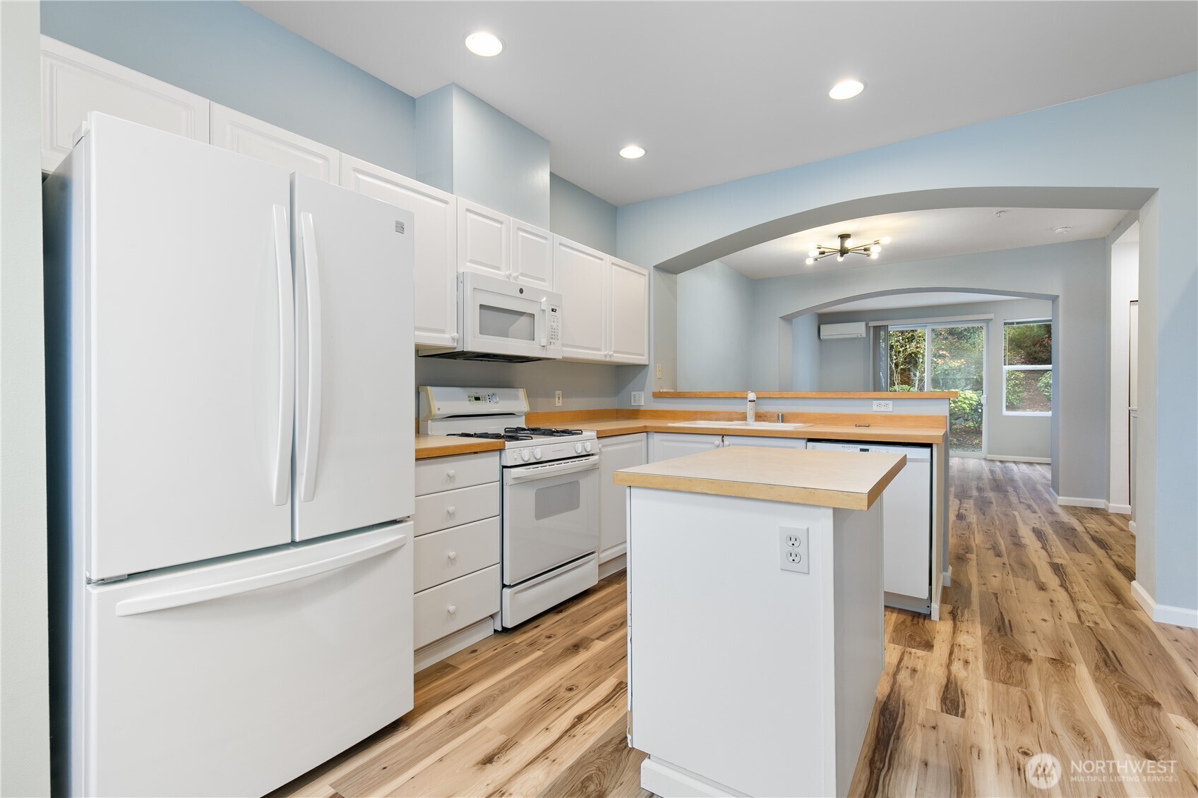 22607 42nd Place South, Unit 13 Kent, WA 98032 - Photo 5 of 19 a kitchen with a sink a refrigerator and white cabinets