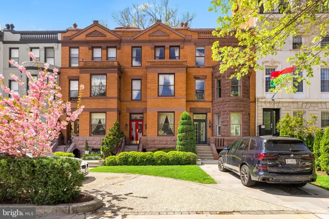 a front view of a residential apartment building with a yard