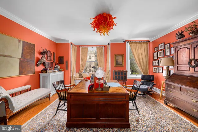 a living room with furniture a large window and a chandelier