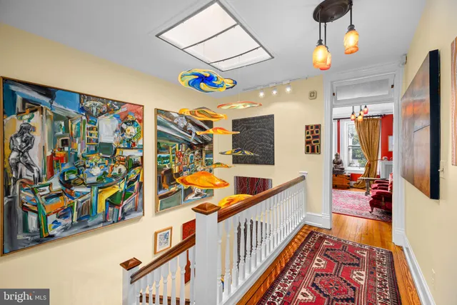 a view of a hallway with a dining table chairs and couches