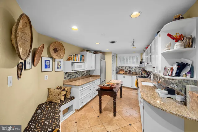 a living room with furniture and a painting on the wall