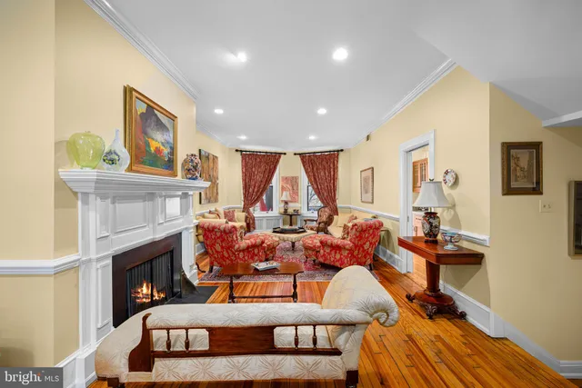 a living room with furniture a fireplace and a window