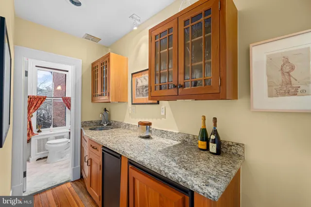 a kitchen with stainless steel appliances granite countertop a sink and dishwasher cabinets with wooden floor