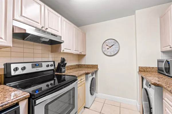 a kitchen with a stove and a refrigerator
