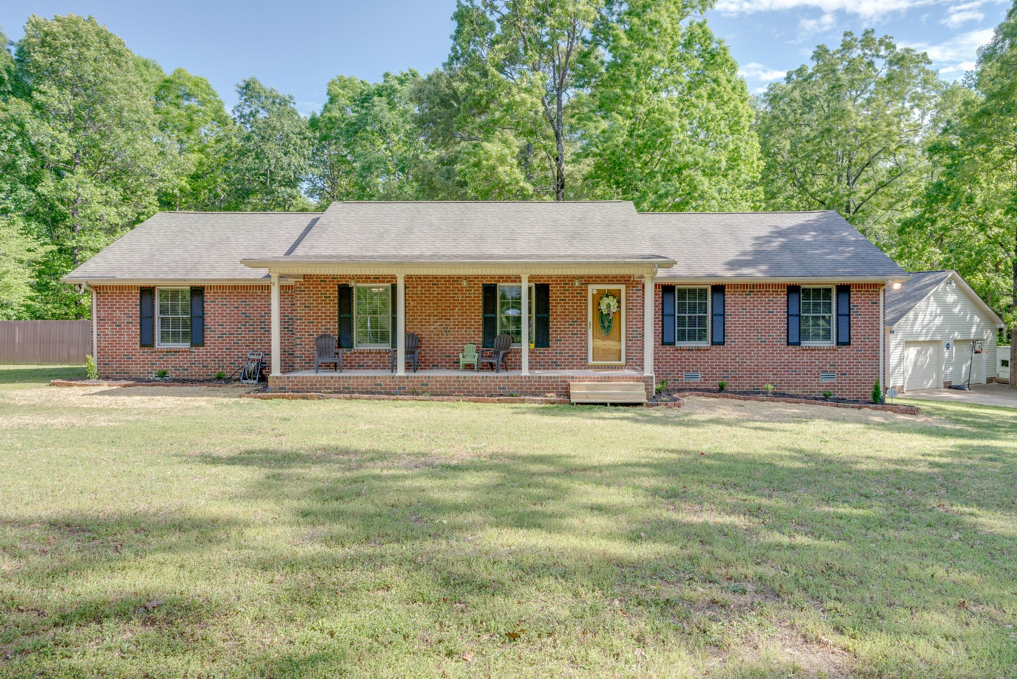 a front view of a house with a garden