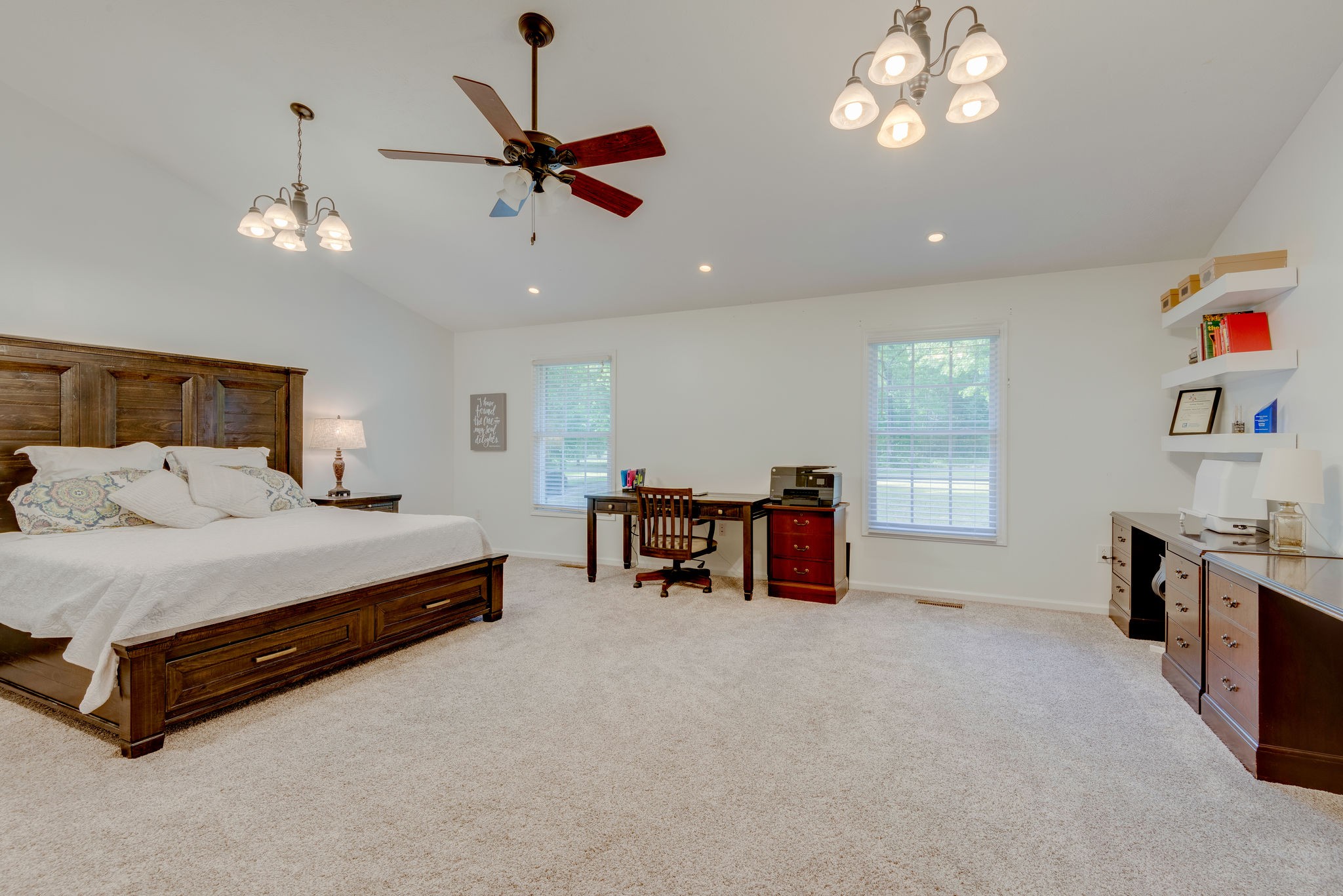 770 Iron Hill Road Burns, TN 37029 - Photo 15 of 28 a spacious bedroom with a bed and a chandelier