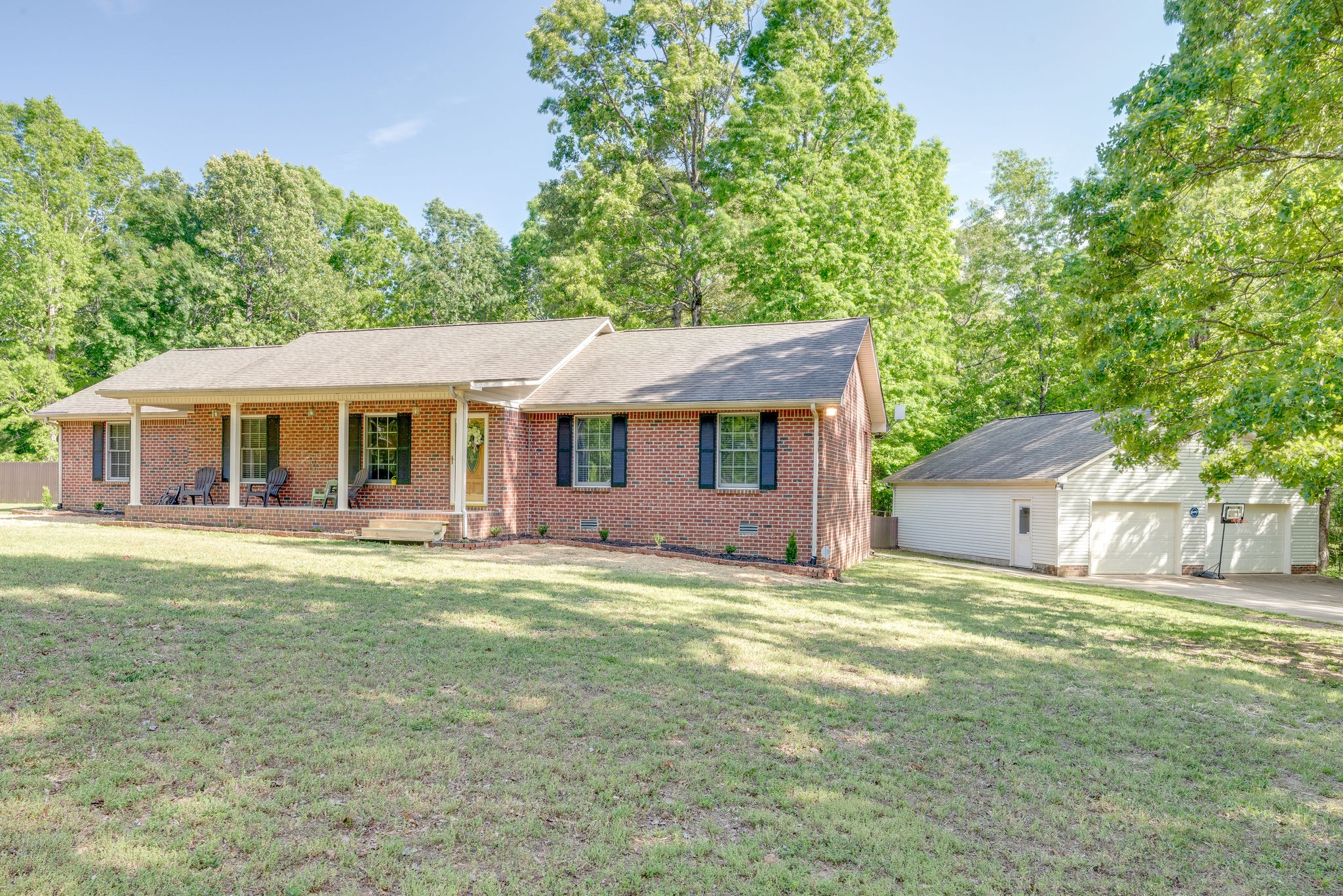 770 Iron Hill Road Burns, TN 37029 - Photo 2 of 28 a front view of a house with a garden and porch