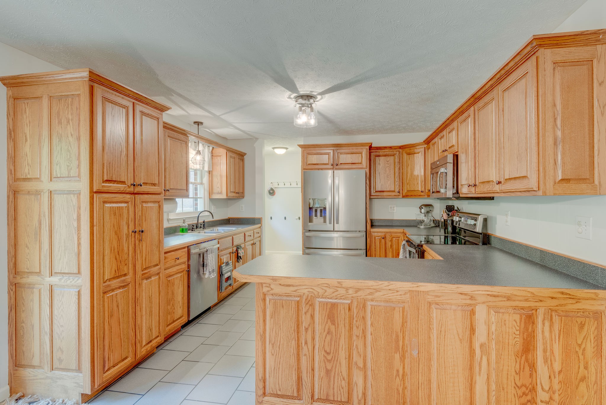 770 Iron Hill Road Burns, TN 37029 - Photo 8 of 28 a kitchen with stainless steel appliances granite countertop a refrigerator a stove and a sink with cabinets