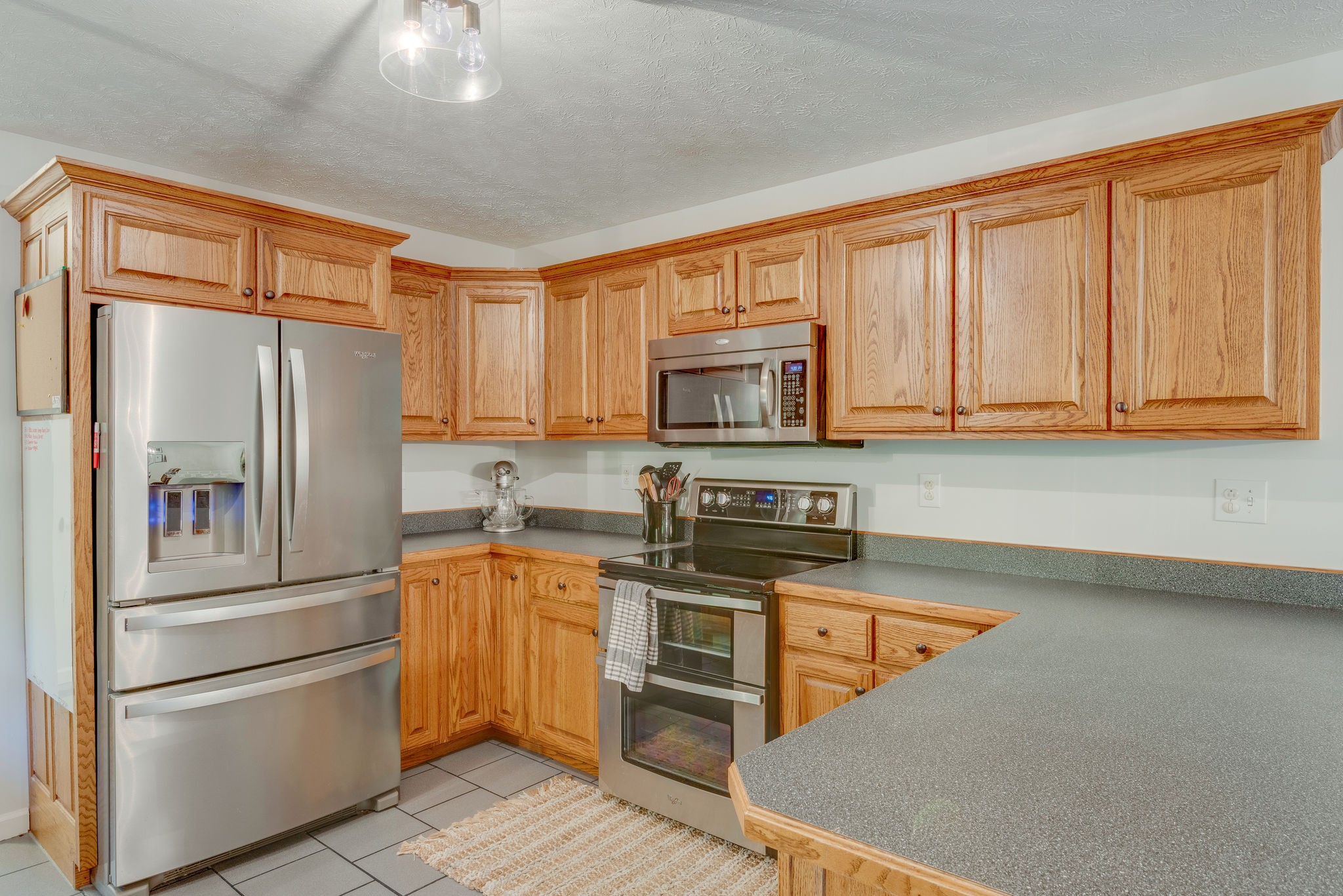 770 Iron Hill Road Burns, TN 37029 - Photo 9 of 28 a kitchen with stainless steel appliances granite countertop a refrigerator stove top oven and sink