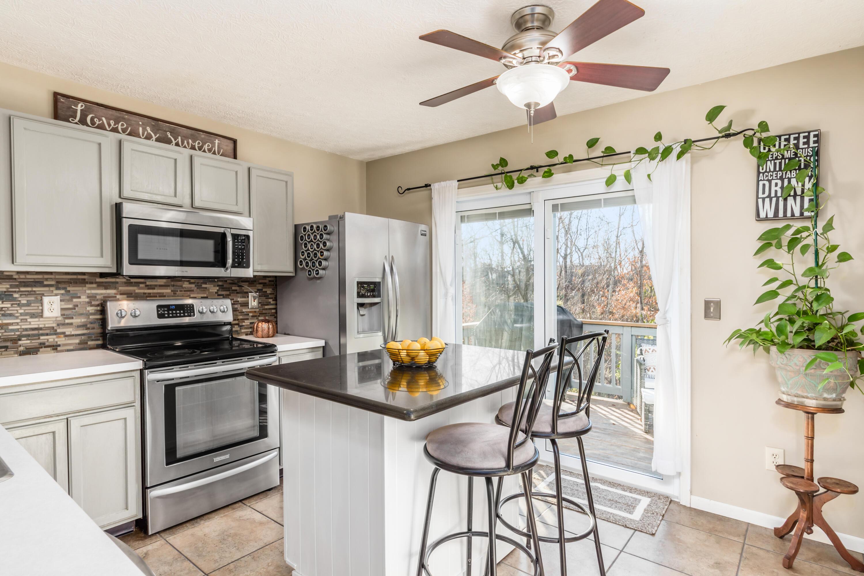 565 Marcum Road Blacklick, OH 43004 - Photo 8 of 29 Beautiful white cabinets, floating center island w/granite counter top & mosaic backsplash